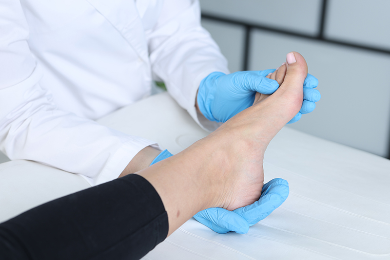 Foot specialist examining a patient's foot during a consultation